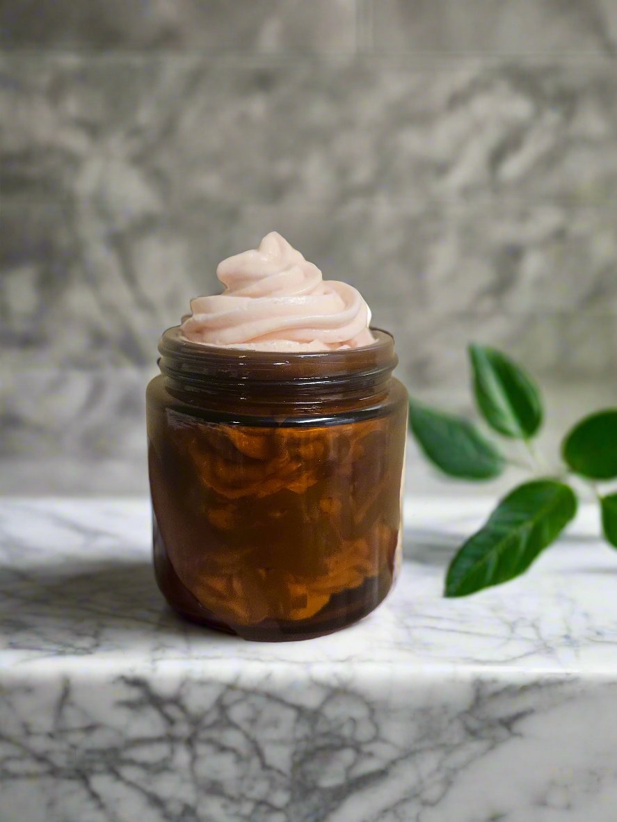 jar of body butter in bathroom on marble countertop